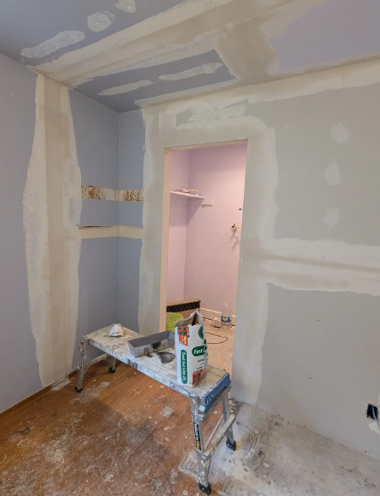 Drywall repair in progress — walls and ceiling