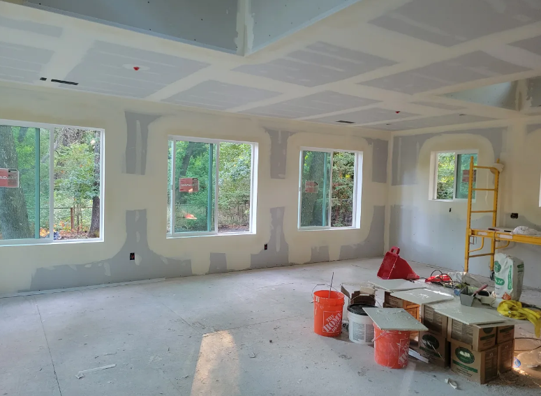 New drywall installation — large room with windows